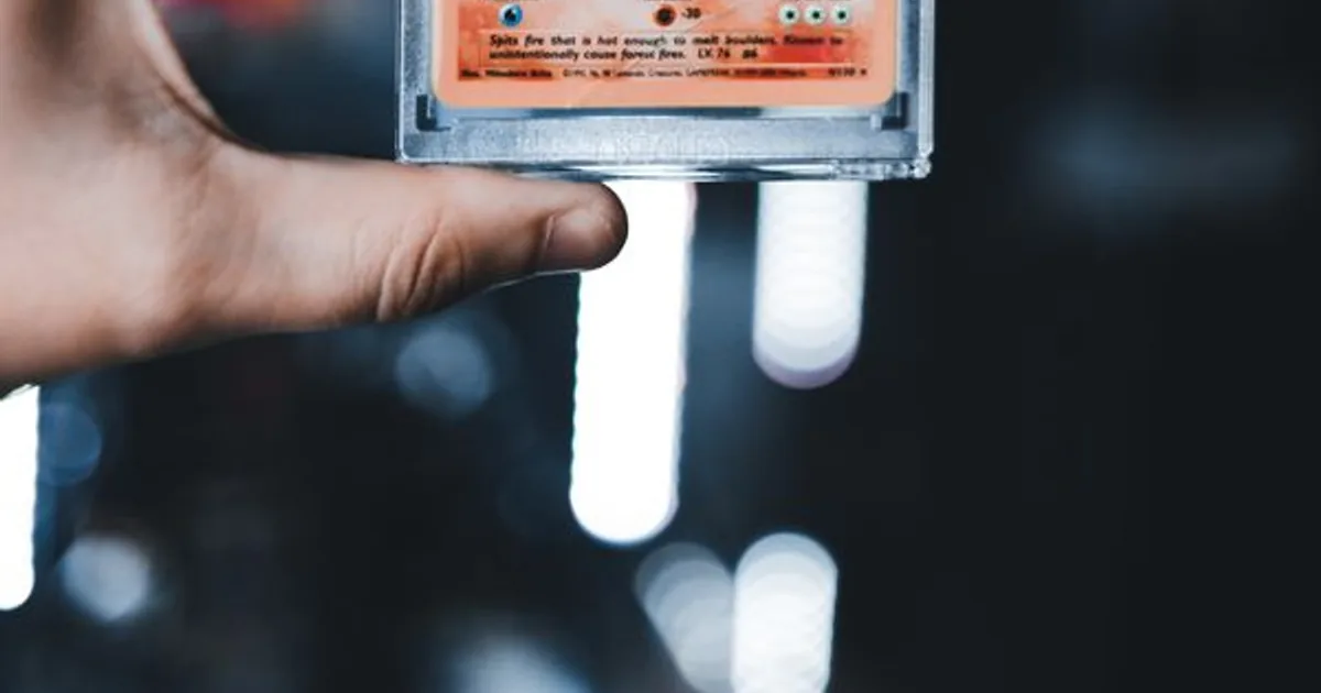 Close-up of a trading card held in hand to inspect its condition