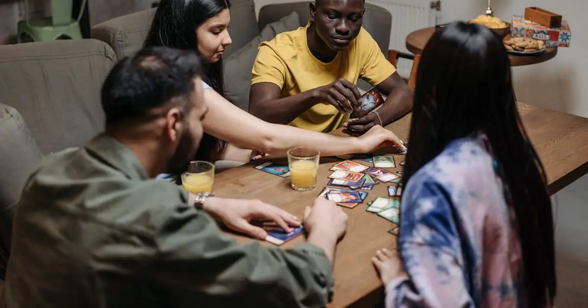 Trading cards fanned out on a table showing foil and rare cards