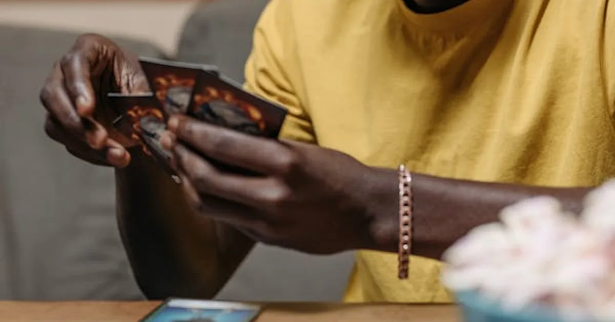 A collector holding a handful of trading cards