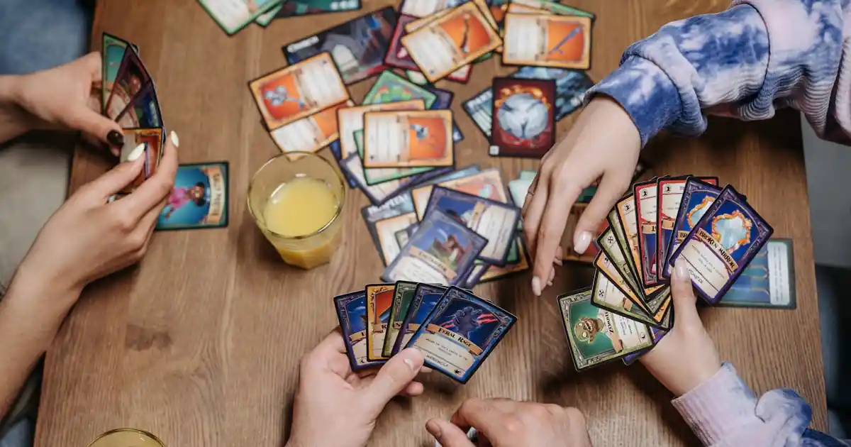 Friends playing a trading card game at a table
