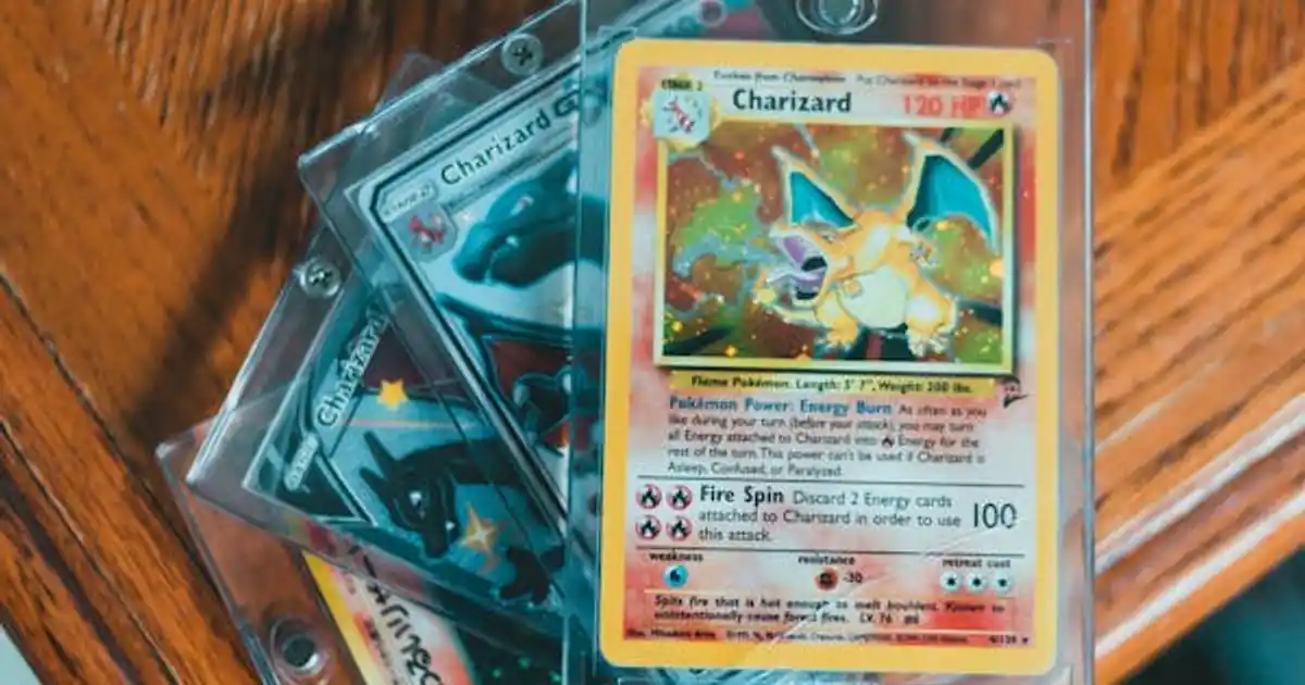 Graded Pokemon cards in protective slabs on a wooden table
