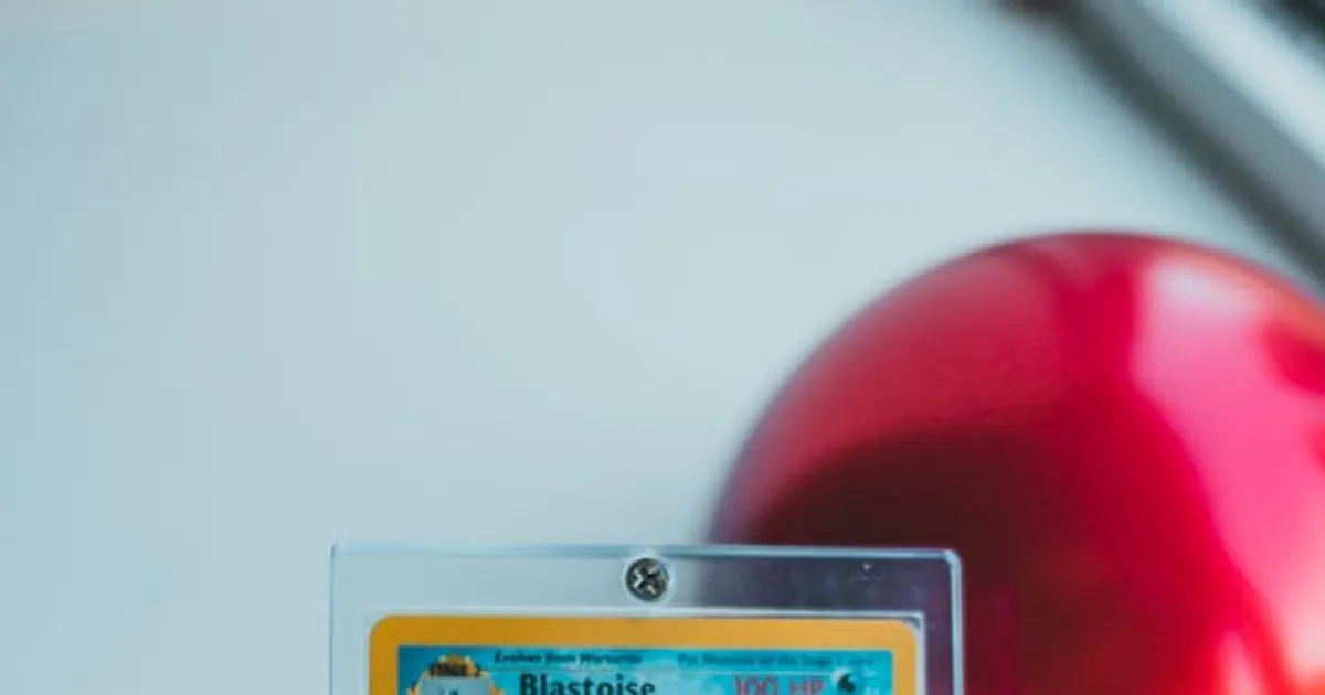 Holographic Blastoise Pokemon card in a protective case