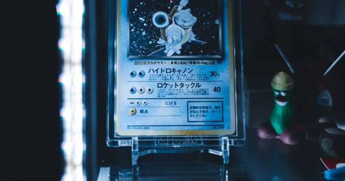 Pokémon cards arranged beside a phone showing a price chart trending up
